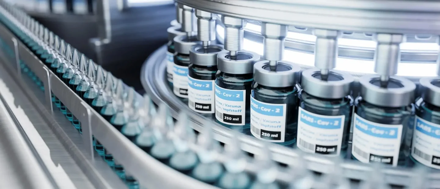 Automated pharmaceutical production line filling vaccine vials in sterile environment for cold chain storage and distribution